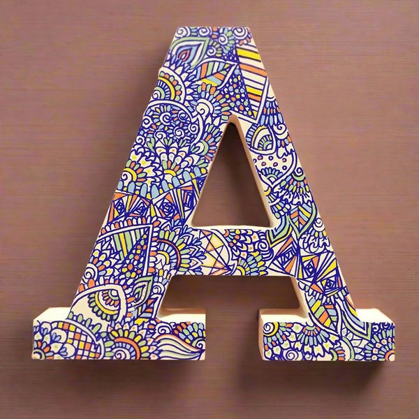 A white Letter A with doodles drawn in Blue and colored in green, orange blue and yellow