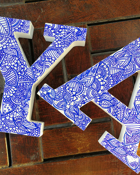 A white Letter A and Y with doodles drawn in blue