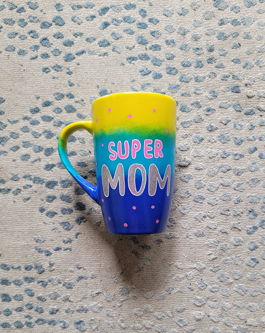 A Gradient colored mug (Yellow blue and ultramarine) with the words "Super Mom" with pink dots scattered all over