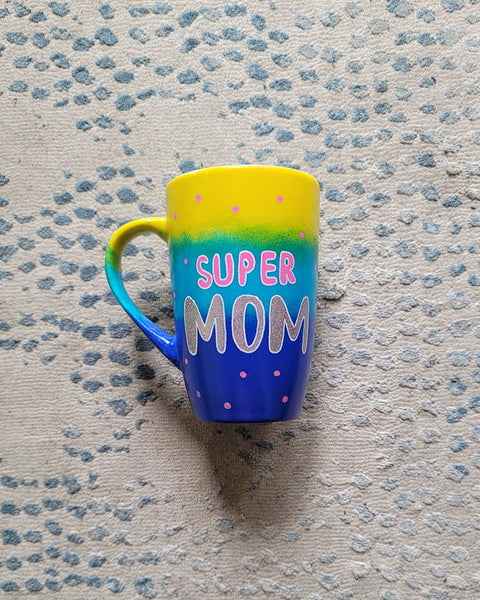 A Gradient colored mug (Yellow blue and ultramarine) with the words "Super Mom" with pink dots scattered all over