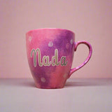 A Hand painted pink galaxy mug with the name 