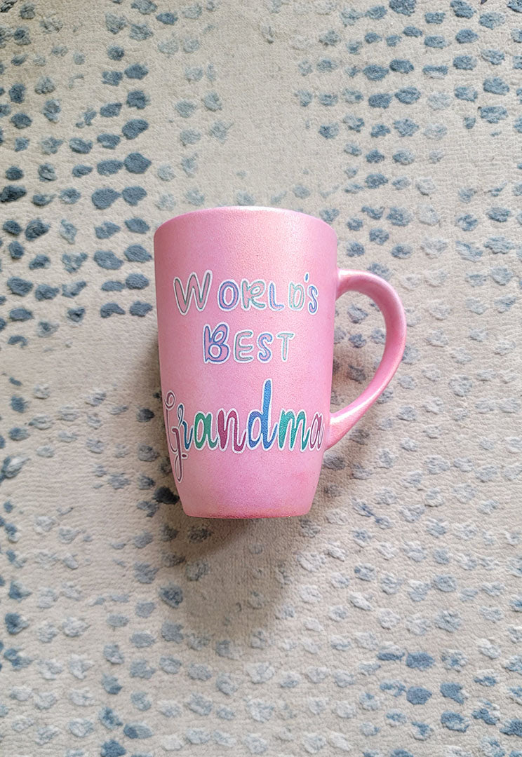 A Shimmery pink mug with the words "Worlds Best Grandma"