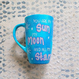 A Blue Galaxy Hand painted mug with the sentence 