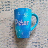 A Blue Galaxy hand painted mug with the name 