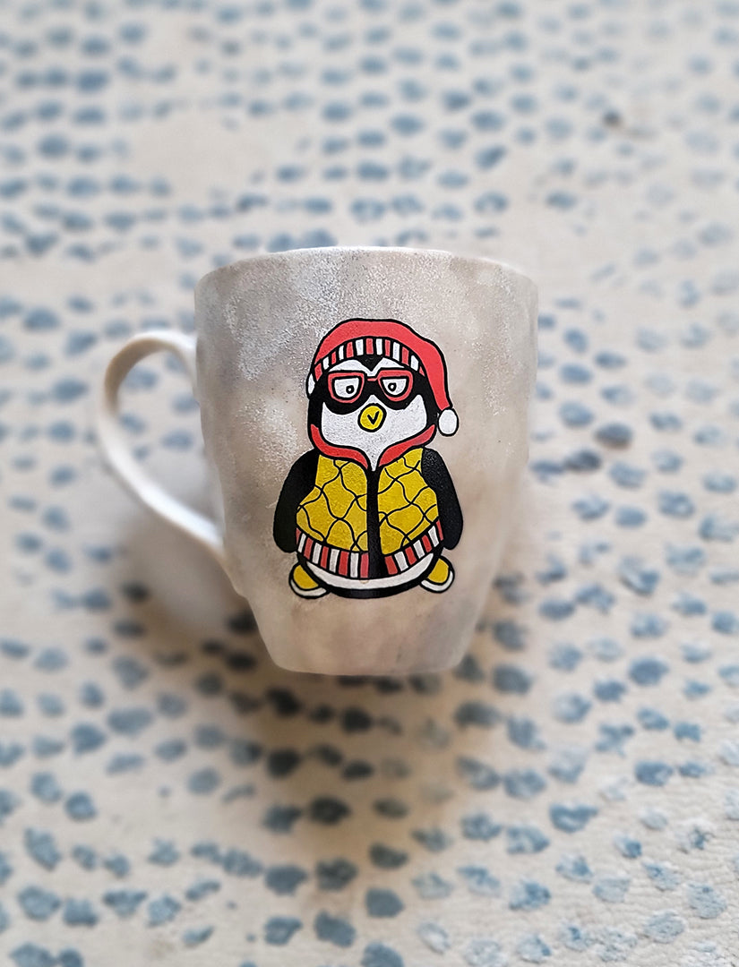 A Taupe Hand painted mug with a fully dressed penguin on it