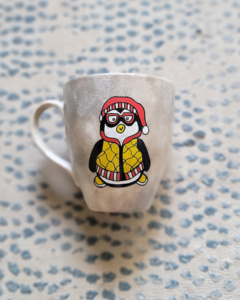 A Taupe Hand painted mug with a fully dressed penguin on it