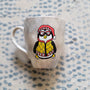 A Taupe Hand painted mug with a fully dressed penguin on it