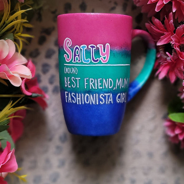 A gradient colored mug (from top fushia then green then blue) with the name sally wirten and then a white line underneath it and then the words Noun in brackets and below it "Best friend, Mum, fashionista Girl"