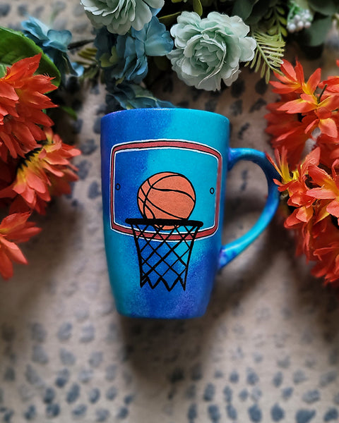 A Blue Hand painted mug with a drawing of a basketball in the net