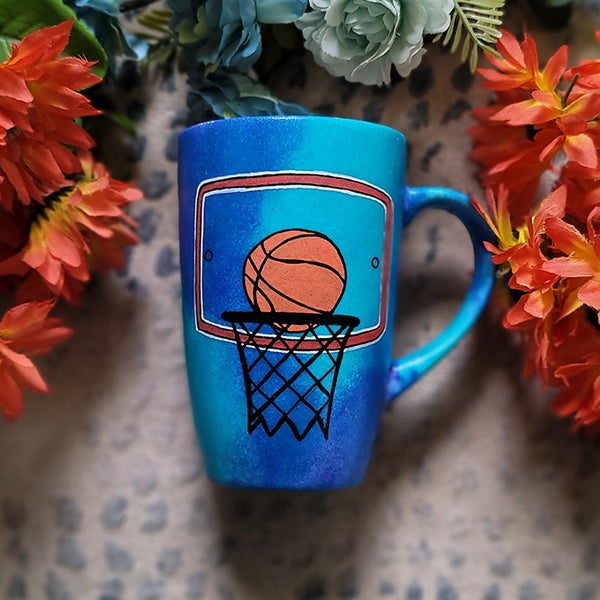 A Blue Hand painted mug with a drawing of a basketball in the net