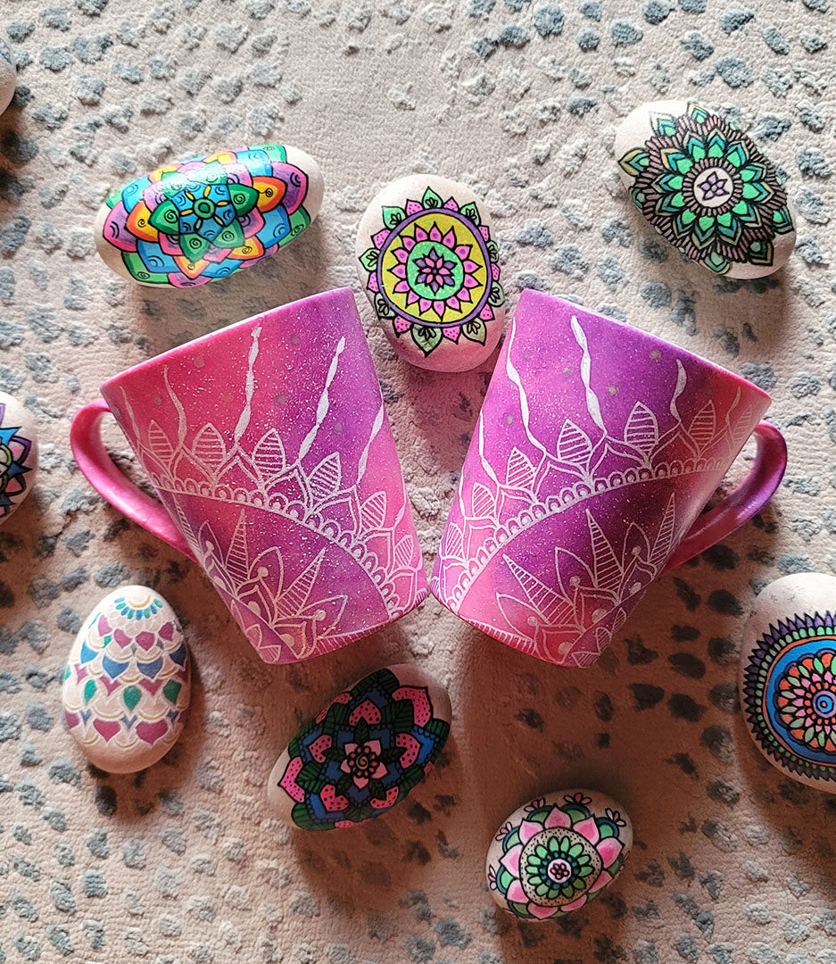 2 hand-painted Pink Galaxy Mugs with a quarter mandala drawn on each at the corner