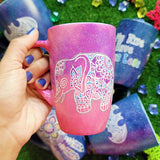 A Pink Galaxy hand painted mug with an elephant zentangle design on it in white