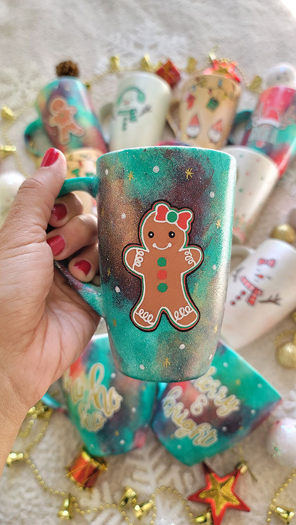 A Christmas hand painted mug with aa gingerbread cookie girl on it with a bow