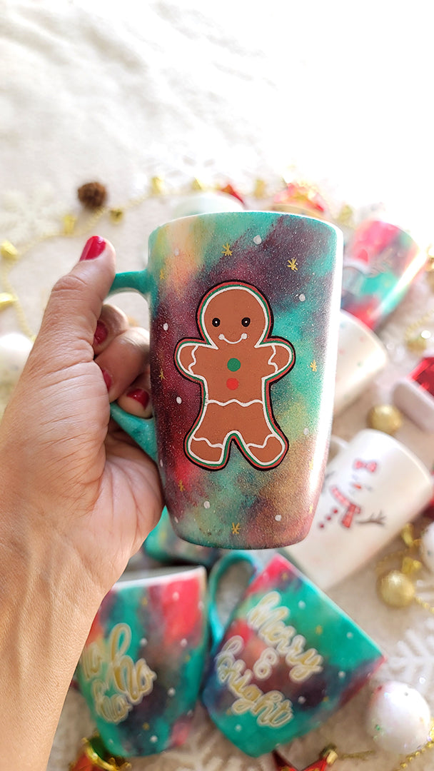 a christmas colored hand painted mug with a gingerbread cookie boy painted on it