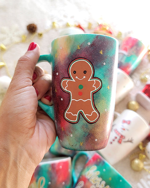 a christmas colored hand painted mug with a gingerbread cookie boy painted on it