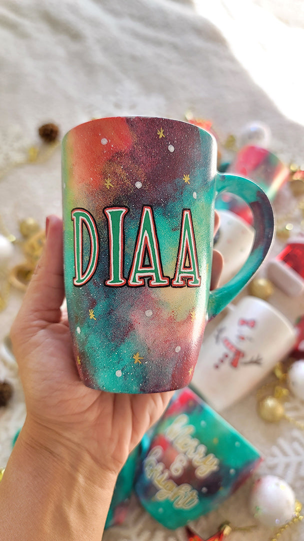 a christmas colored hand painted mug with a the name "Diaa"