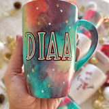 a christmas colored hand painted mug with a the name 