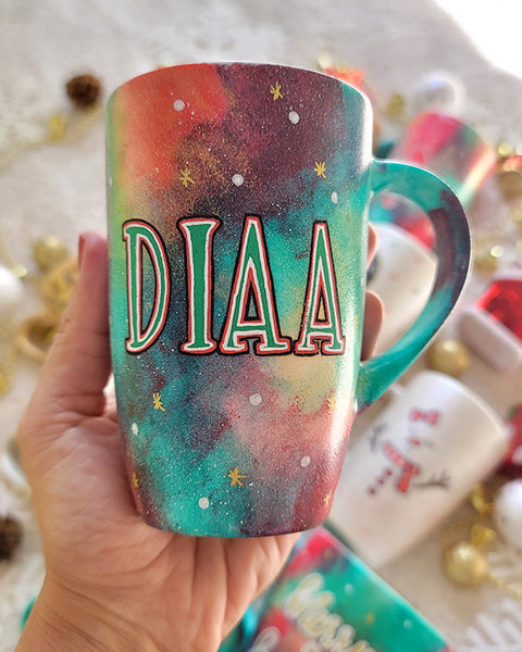 a christmas colored hand painted mug with a the name "Diaa"