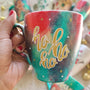 A Christmas galaxy colored hand painted mug with the words "HOHOHO" written gold with white dots and gold stars scattered all over