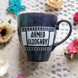 A dark sky mug with part of a film roll with the name 