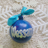 A Blue galaxy hand painted ornament with the name 