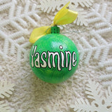 A lime green galaxy hand painted ornament with the name 