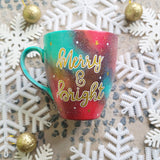 A Christmas galaxy colored hand painted mug with the words 