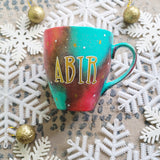 A Christmas galaxy colored hand painted mug with the name 