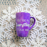 A Purple Galaxy hand-painted mug with the sentence 