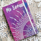 A Pink Galaxy hand painted notebook with a quarter mandala drawn from the corner and the name 