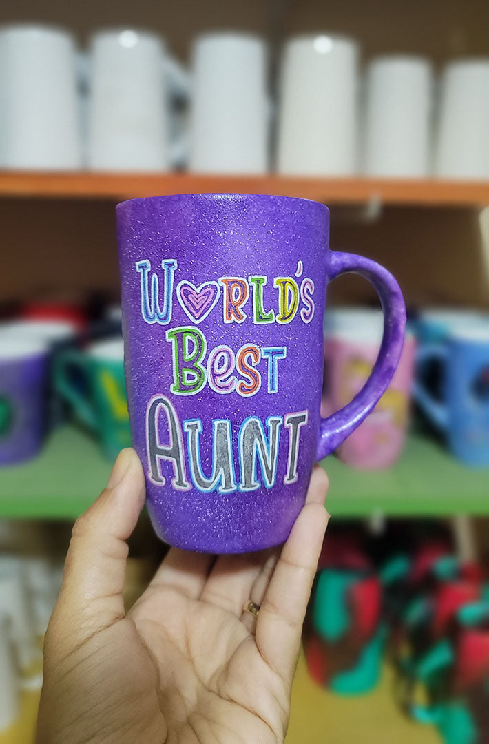 A Purple galaxy hand painted mug with the words "Worlds Best Aunt"