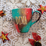 A Christmas hand painted mug with the name 