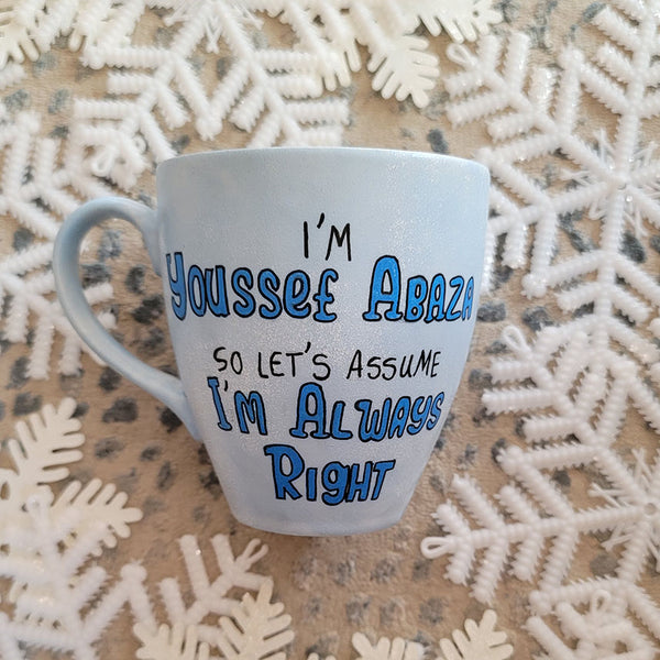 A baby blue hand painted mug with the words "I'm Youssef Abaza,  So lets Assume I'm Always right"