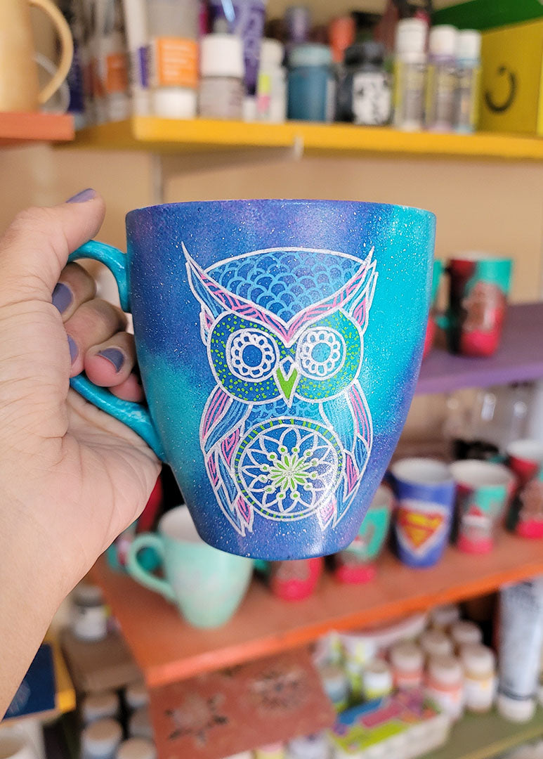 A Blue galaxy hand painted mug with an owl in zentangles drawn on it