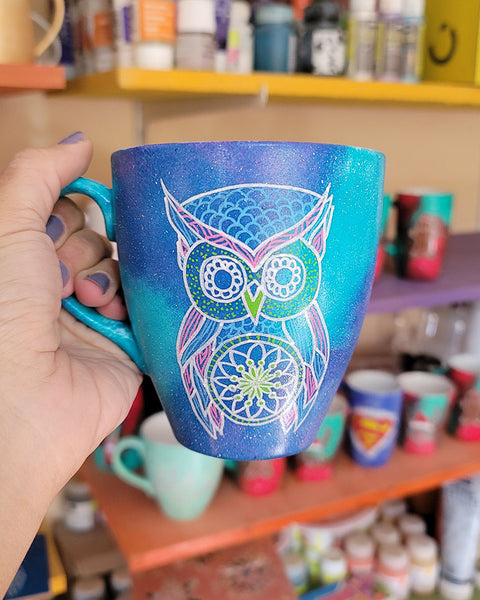 A Blue galaxy hand painted mug with an owl in zentangles drawn on it