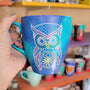 A Blue galaxy hand painted mug with an owl in zentangles drawn on it