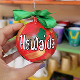 A Colorful hand painted ornament with red background and colors of red green, brown and gold scattered all over with white dots and the name 