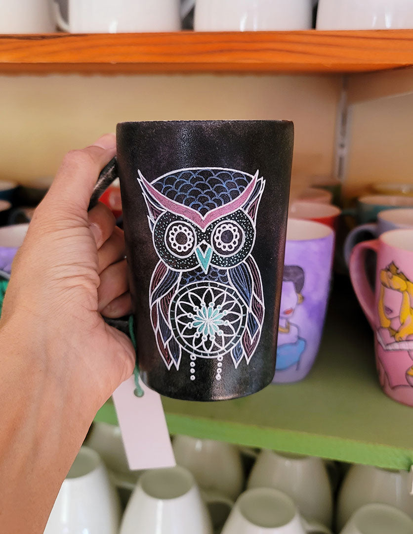 A Drk Sky hand painted mug with an owl in zentangles drawn on it