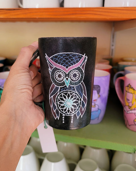 A Drk Sky hand painted mug with an owl in zentangles drawn on it