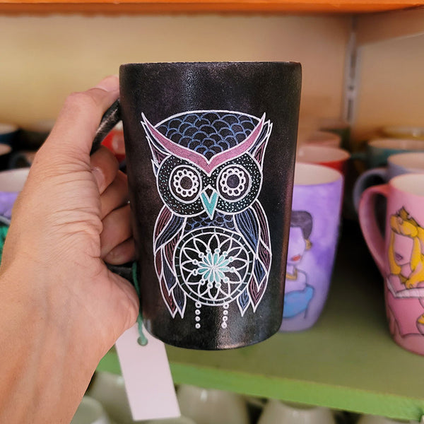 A Drk Sky hand painted mug with an owl in zentangles drawn on it