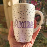 A white pearl hand painted mug with the name 