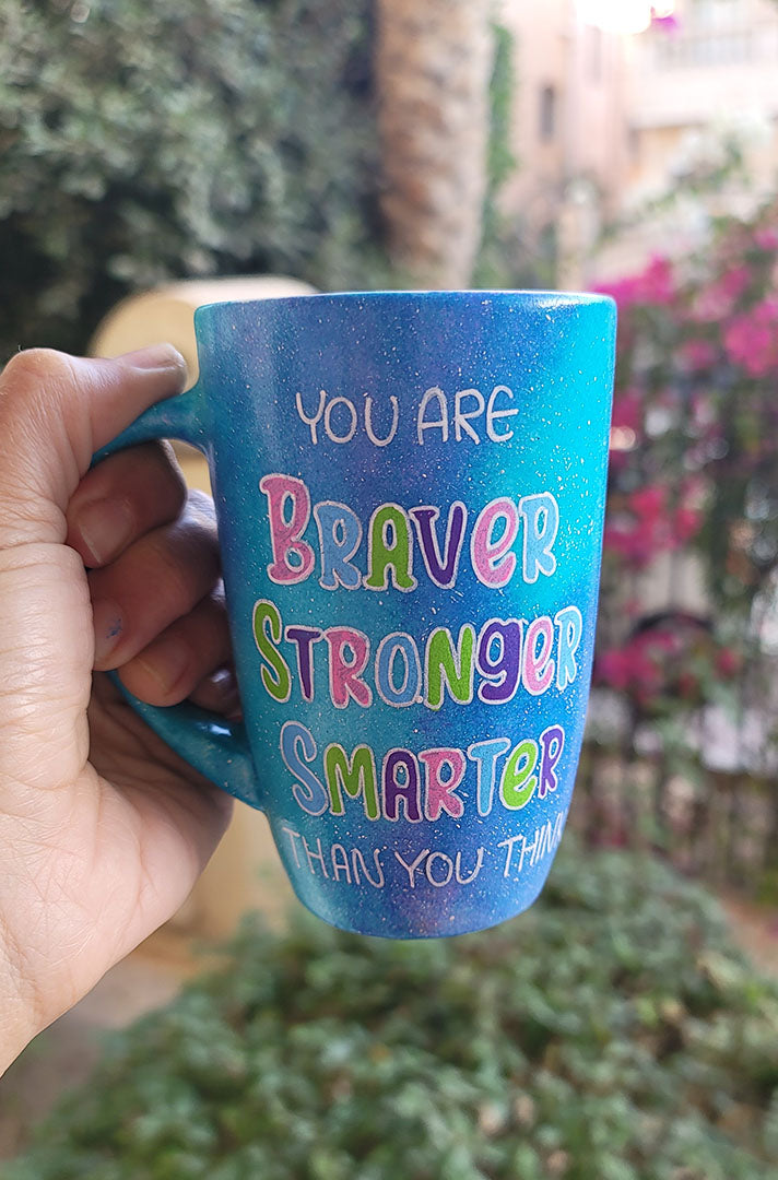 A Blue Galaxy Mug with the words "You are Braver, Stronger, Smarter than you think"