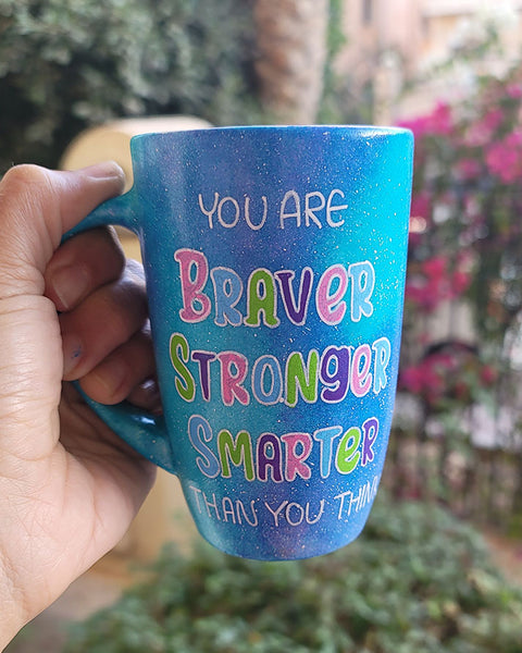 A Blue Galaxy Mug with the words "You are Braver, Stronger, Smarter than you think"