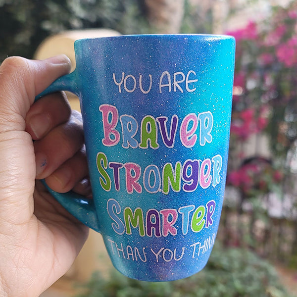 A Blue Galaxy Mug with the words "You are Braver, Stronger, Smarter than you think"