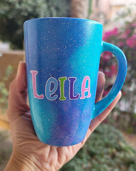 A Blue Galaxy Mug with the words name "Leila"