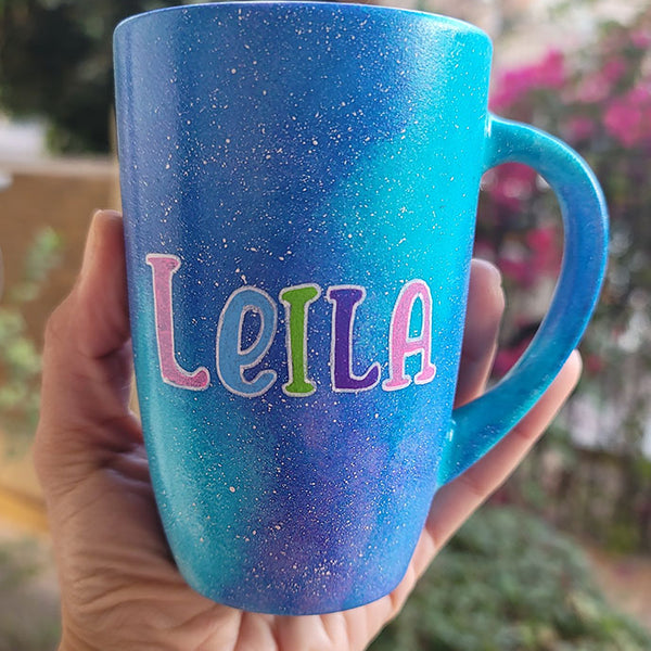 A Blue Galaxy Mug with the words name "Leila"