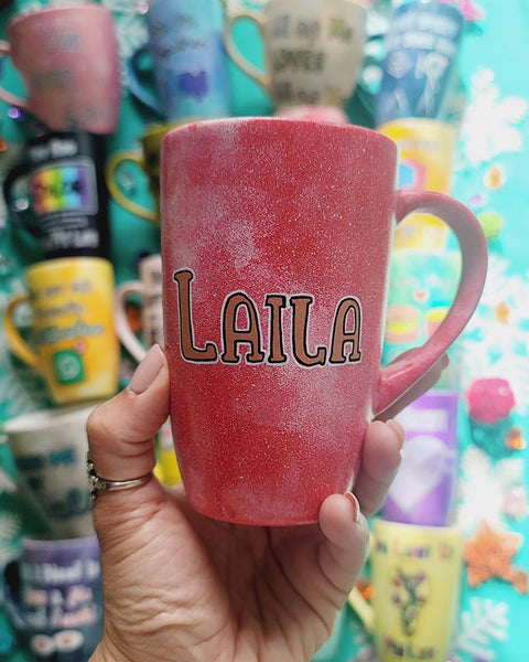 A red galaxy hand painted mug with the name "Laila"