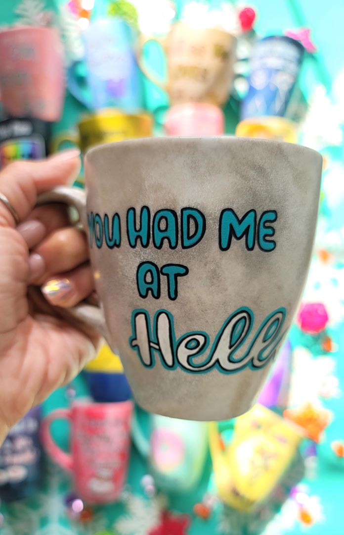 A hand-painted taupe silver mug with the words "You had me at hello"