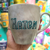 A hand-painted taupe silver mug with the name 