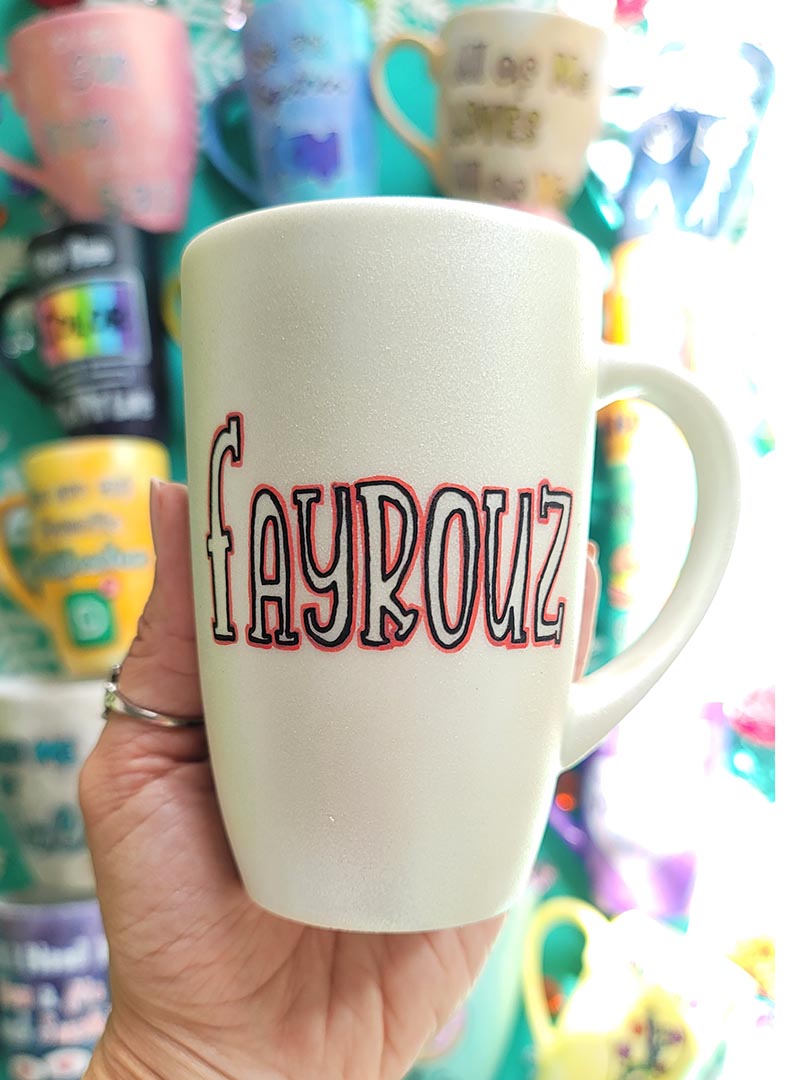 A hand painted pearl  white mug with the name "fayrouz"